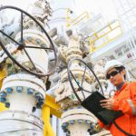 operator recording operation of oil and gas process at oil and rig plant, offshore oil and gas industry, offshore oil and rig in the sea, operator monitor production process, routine daily record.