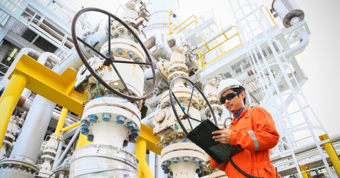 operator recording operation of oil and gas process at oil and rig plant, offshore oil and gas industry, offshore oil and rig in the sea, operator monitor production process, routine daily record.